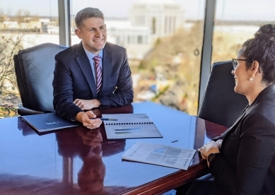 Dan Emmons and Diana Castro discussing business in conference room